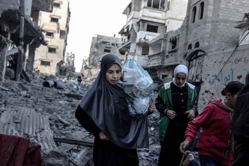 Palestinian women and children carrying belongings flee to safer areas following Israeli bombardments on southern part of Gaza City