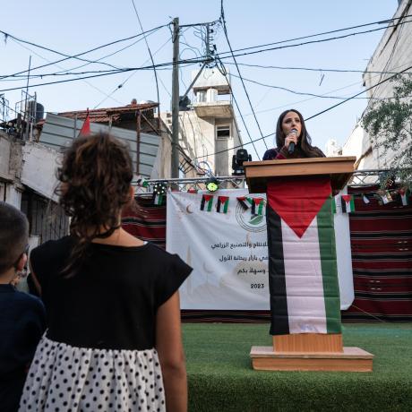 The Rise of Palestinian Women's Leadership in Refugee Camps, Shatha’s speaking at a Bazaar